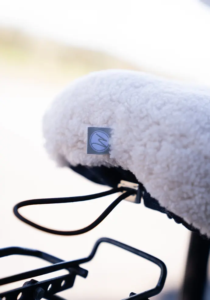 Housse pour selle de vélo avec lien de réglage